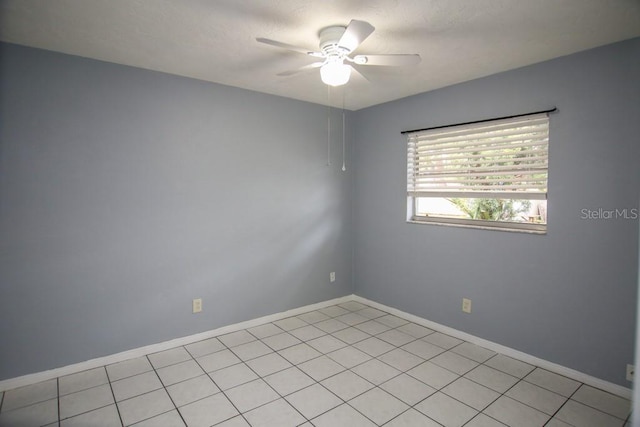 tiled spare room with ceiling fan