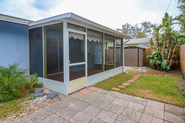 view of home's exterior with a sunroom