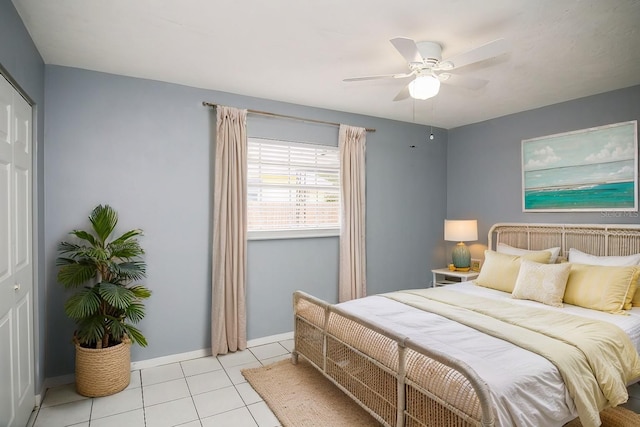 tiled bedroom featuring ceiling fan