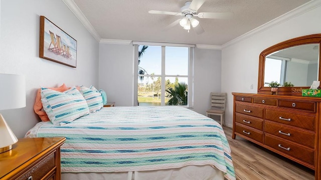 bedroom featuring crown molding, ceiling fan, and light hardwood / wood-style floors