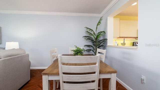 dining room featuring dark parquet flooring and ornamental molding