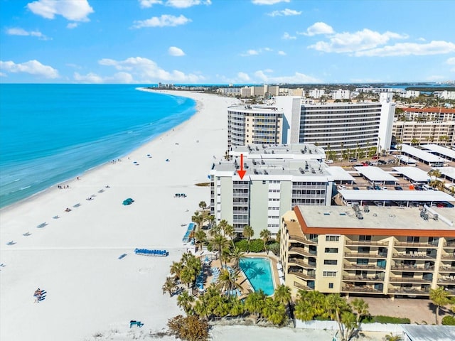 bird's eye view featuring a water view and a beach view