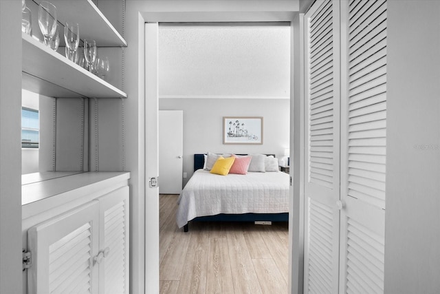 bedroom with hardwood / wood-style flooring and a textured ceiling