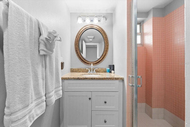 bathroom featuring walk in shower and vanity