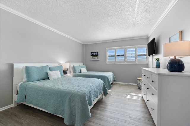 bedroom with crown molding, light hardwood / wood-style flooring, and a textured ceiling