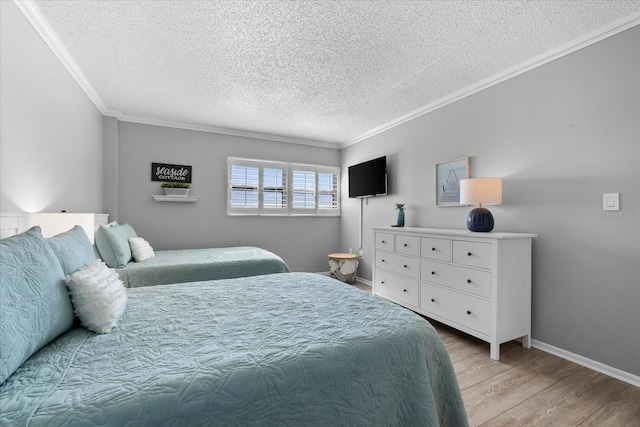 bedroom featuring ornamental molding, a textured ceiling, and light wood-type flooring