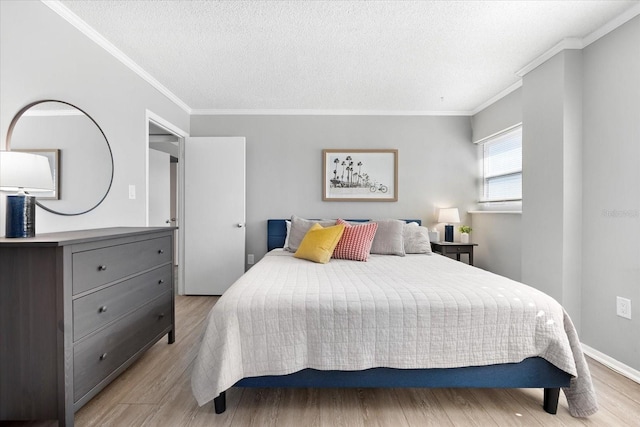 bedroom featuring ornamental molding, a textured ceiling, and light hardwood / wood-style flooring