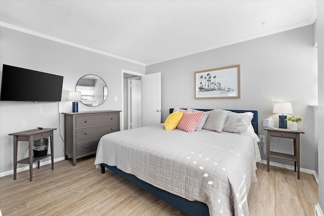 bedroom featuring crown molding, light hardwood / wood-style floors, and a textured ceiling