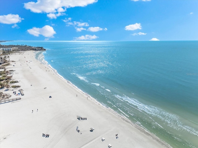 birds eye view of property featuring a beach view and a water view