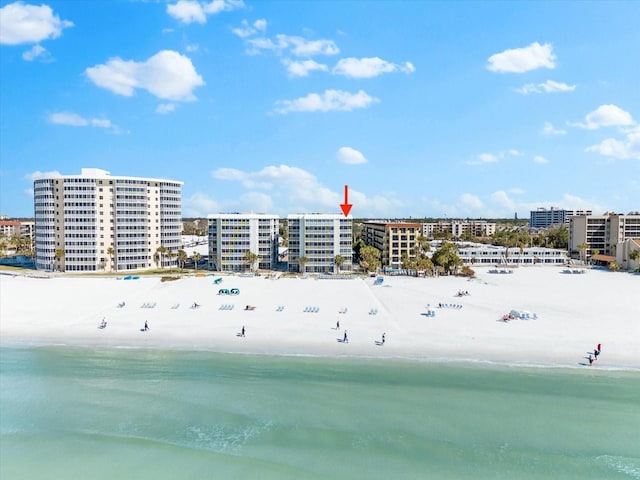 drone / aerial view featuring a water view and a view of the beach