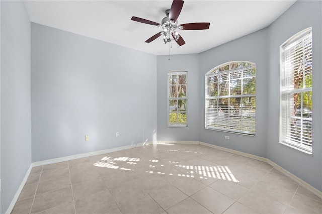 empty room featuring ceiling fan and light tile patterned floors