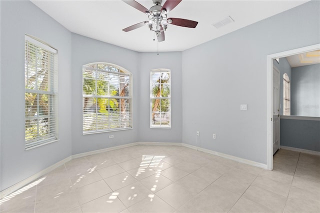 tiled empty room with ceiling fan