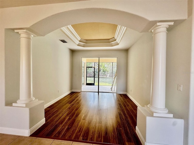 unfurnished room featuring ornate columns, crown molding, and a tray ceiling