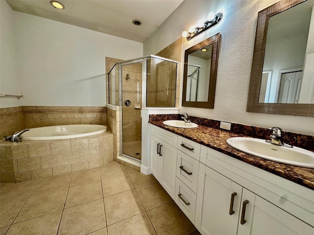 bathroom with tile patterned floors, separate shower and tub, and vanity