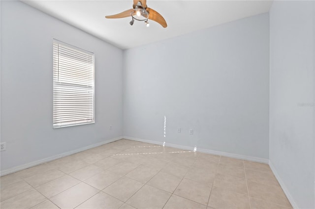 tiled empty room featuring ceiling fan