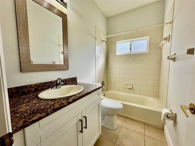 full bathroom with tile patterned floors, vanity, toilet, and tiled shower / bath combo