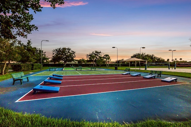 view of property's community featuring tennis court