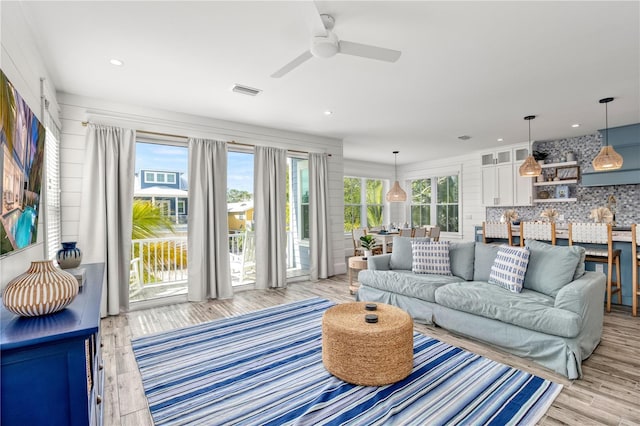 living room with ceiling fan and light hardwood / wood-style floors