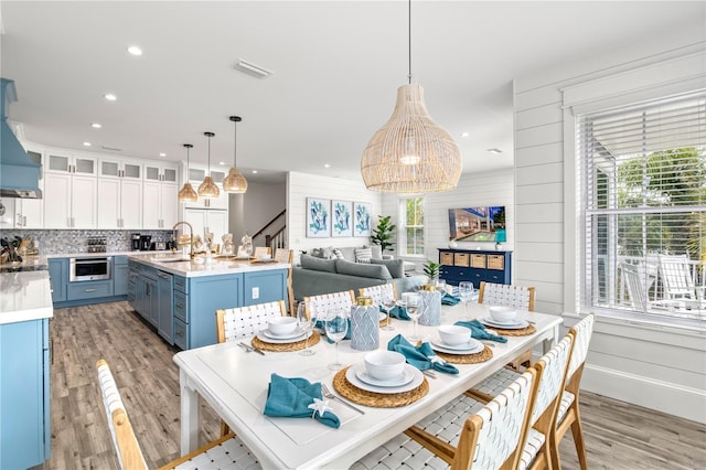 dining area featuring light hardwood / wood-style floors, plenty of natural light, and sink