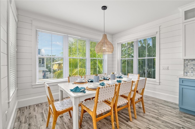 dining area featuring light wood-type flooring and plenty of natural light