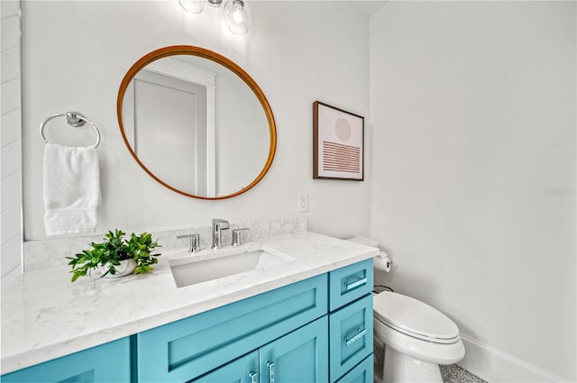 bathroom featuring toilet and vanity