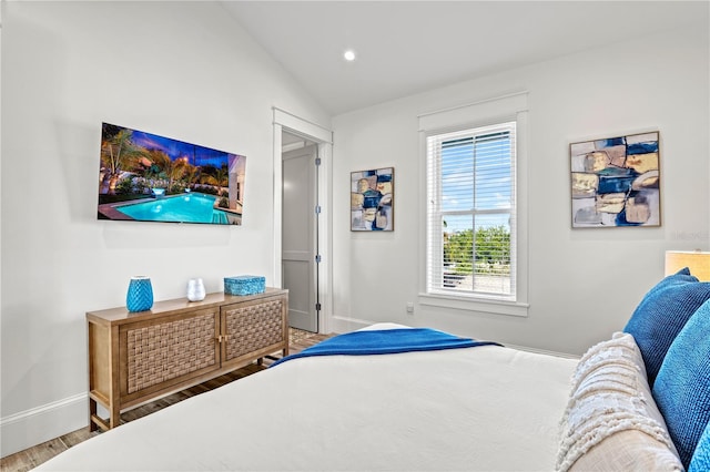 bedroom featuring vaulted ceiling and hardwood / wood-style flooring