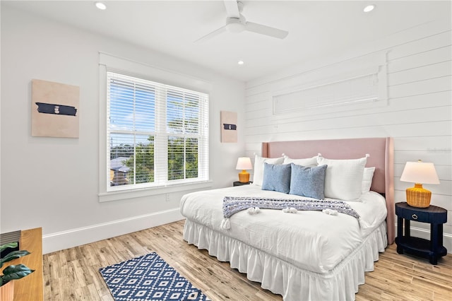 bedroom with ceiling fan and light hardwood / wood-style flooring