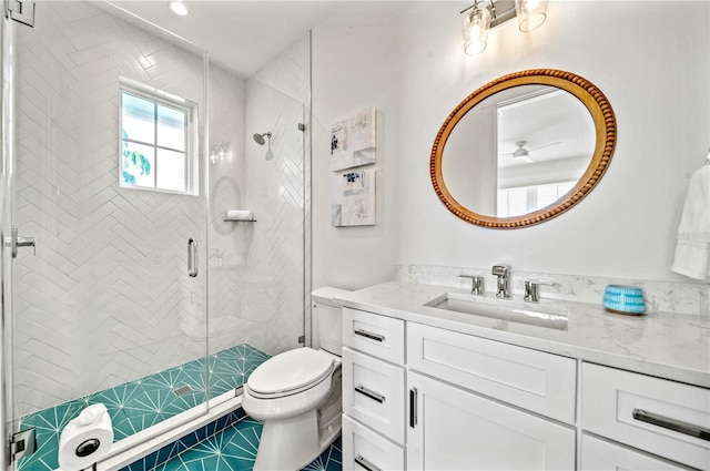 bathroom featuring a shower with shower door, tile patterned floors, vanity, and toilet