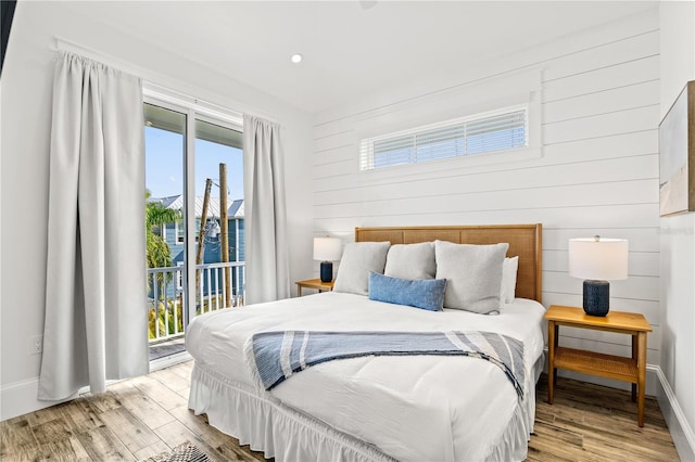 bedroom featuring access to exterior and light hardwood / wood-style flooring