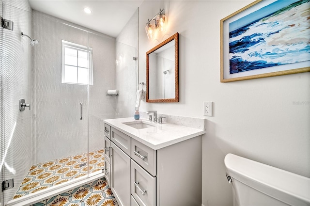 bathroom featuring toilet, a shower with door, and vanity