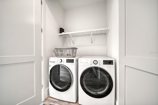 washroom featuring washer and dryer and light hardwood / wood-style flooring