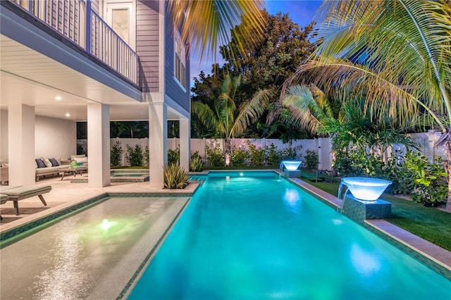 view of swimming pool featuring pool water feature and a patio