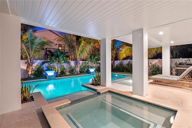 view of swimming pool featuring an in ground hot tub and a patio