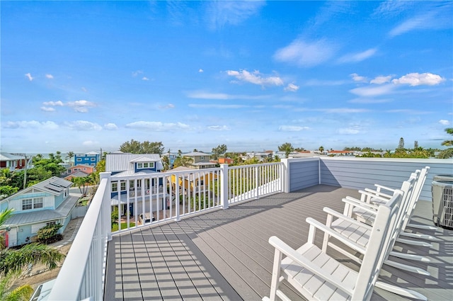 wooden terrace featuring central AC unit