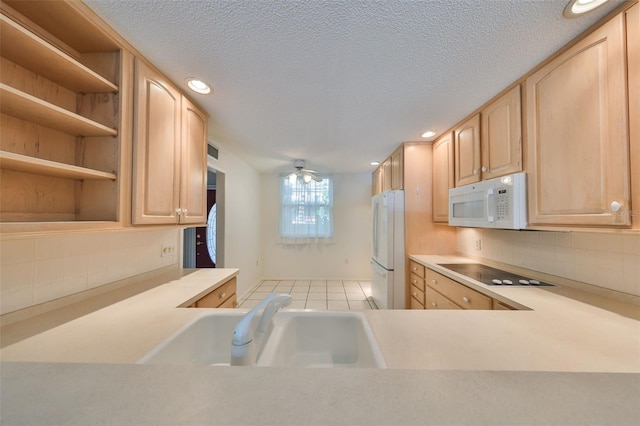 kitchen with light brown cabinetry, sink, tasteful backsplash, a textured ceiling, and white appliances