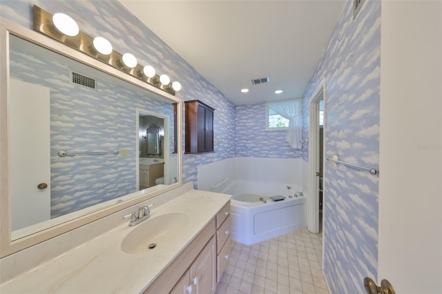 bathroom featuring tile patterned floors, vanity, and a bathtub