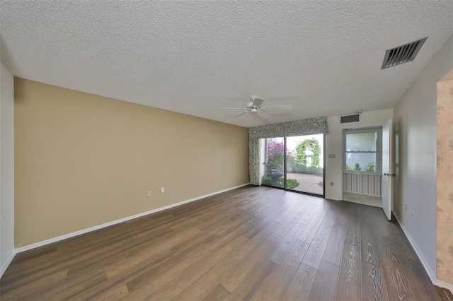 empty room featuring hardwood / wood-style flooring, ceiling fan, and a textured ceiling