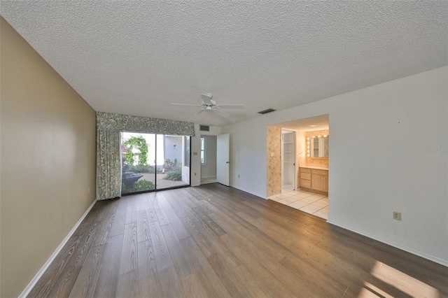 spare room featuring ceiling fan, a textured ceiling, and light hardwood / wood-style floors