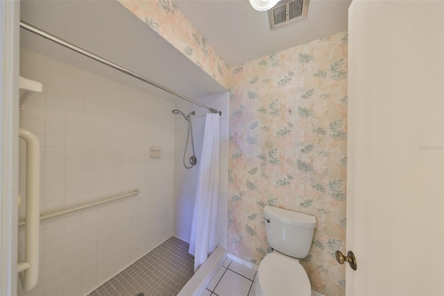 bathroom with a shower with curtain, toilet, and tile patterned flooring