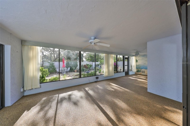 unfurnished sunroom featuring ceiling fan