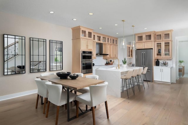 dining space featuring light wood-type flooring