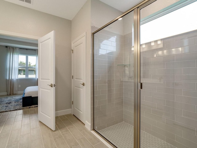 bathroom with a shower with door