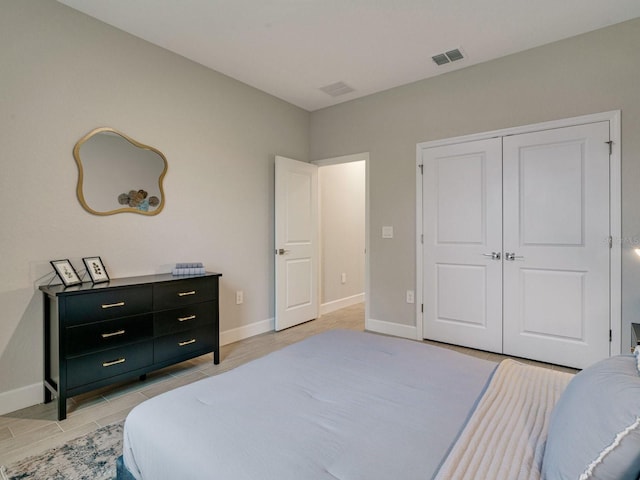 bedroom with light hardwood / wood-style flooring and a closet