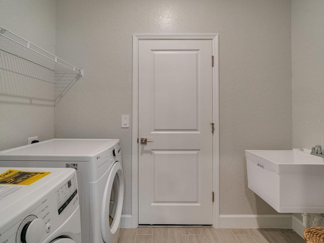 laundry room featuring washer and dryer and sink