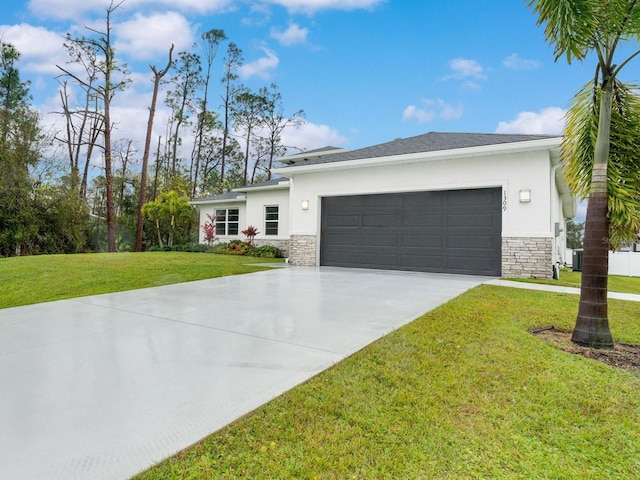 view of front of house featuring a garage, central AC, and a front lawn