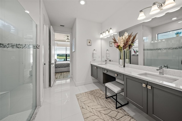 bathroom featuring walk in shower, vanity, and tile patterned flooring