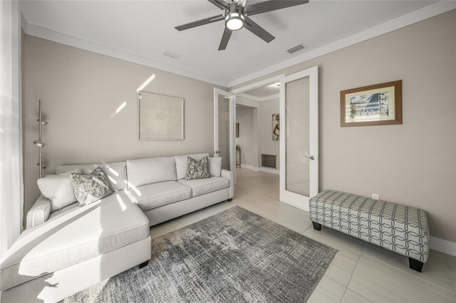 tiled living room with ceiling fan and ornamental molding