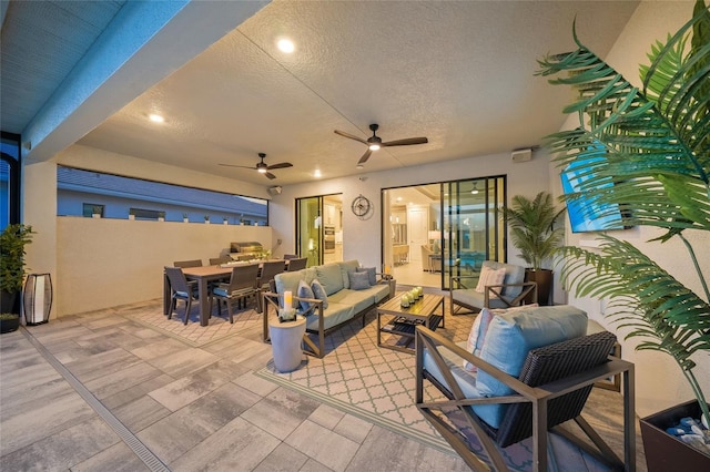 view of patio with an outdoor living space and ceiling fan