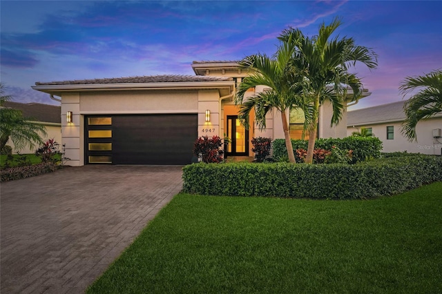 view of front of house with a yard and a garage