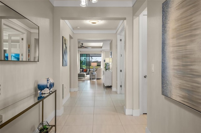 hall with light tile patterned floors and crown molding